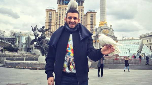 Muhanad laughs as a pigeon stands on his head. (Facebook)