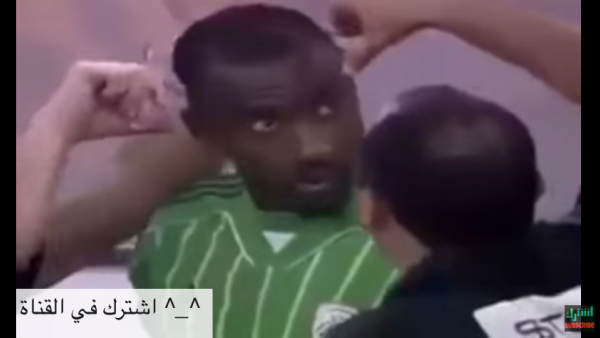 A screenshot from a video showing a Saudi Arabian soccer player getting his hair cut during a game because his hair style was deemed un-Islamic. 