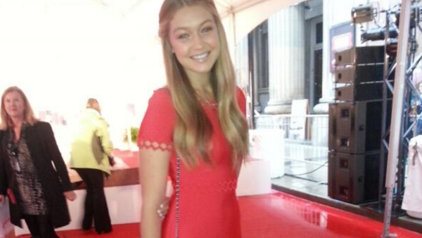 Red really suits Gigi's bronze complexion and blond locks. (Snapshot)