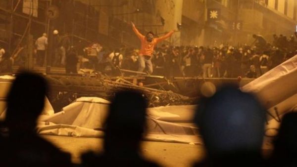 A protester gestures towards riot police after they fired tear gas in front of a barricade in Istanbul on Tuesday, June 4, 2013. (Image credit: Reuters)