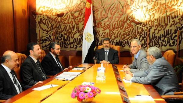  In this handout picture released by the Egyptian Presidency, Egyptian President Mohamed Morsi (C) meets with his prime minister Hisham Kandil (3rd L) and other ministers in Cairo on July 1, 2013. 