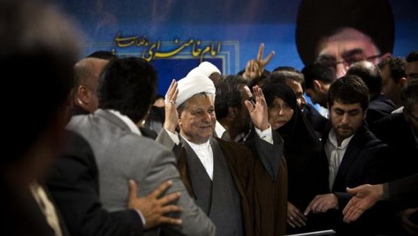 Former Iranian president Akbar Hashemi Rafsanjani (C) arrives with his daughter Fatemeh (C-R) to register his candidacy for the upcoming presidential election at the interior ministry in Tehran on May 11, 2013. (AFP)