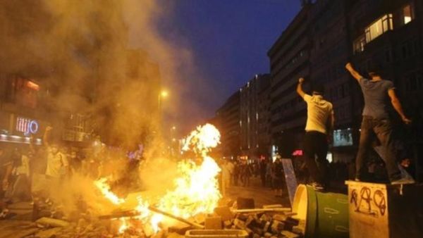 Anti-government protesters shout slogans as they stand on barricades in Istanbul June 16, 2013.