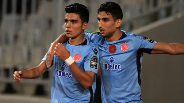 Wydad's striker Achraf Bencharki (L) celebrates his equalising goal with his teammate during the CAF Champions League final football match between Al-Ahly vs Wydad Casablanca at the Borg El Arab Stadium in Alexandria on October 28, 2017.
STRINGER / AFP