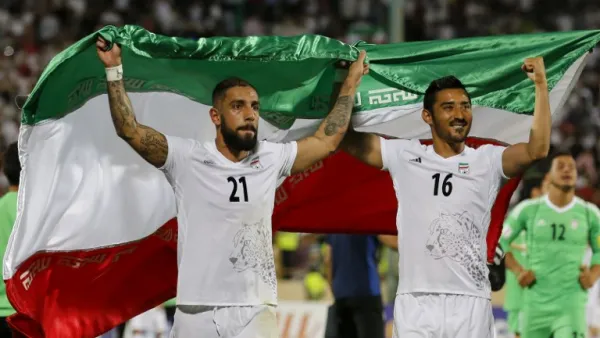 Iran's Ashkan Dejagah (L) Reza Ghoochannejad (R) celebrates among players after winning the 2018 World Cup qualifying football match between Iran and Uzbekistan at the Azadi Stadium in Tehran on June 12, 2017. Iran won 2-0.
ATTA KENARE / AFP