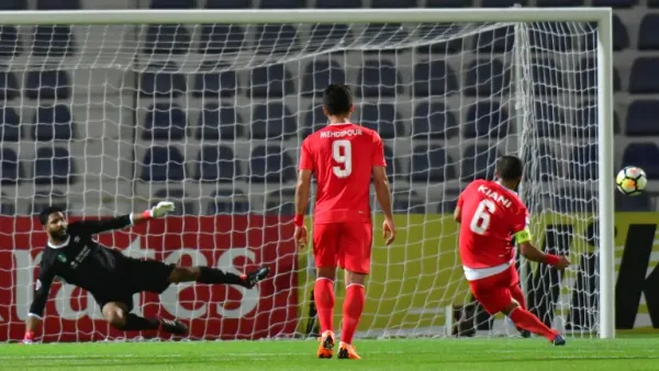 Tractorsazi Tabriz's midfielder Mehdi Kiani (R) kicks and misses a penalty during the AFC Champions League football match Tractorsazi Tabriz vs Al Ahli at the Tahnoun Bin Mohammed Stadium in Al Ain on April 3, 2018.
GIUSEPPE CACACE / AFP