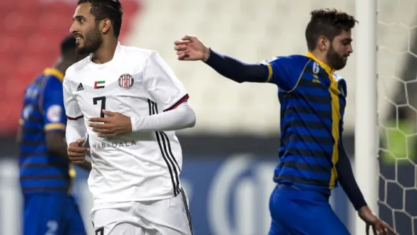 UAE's Al-Jazira's Ali Ahmed Mabkhout (L) celebrates after scoring against Qatar's al-Gharafa's Rubert Fasciana (R) during the AFC Champions League Round 1 Group (A) Match between al-Jazira vs al-Gharafa at the Mohammed Bin Zayed Stadium in abu Dhabi on February 12, 2018.
NEZAR BALOUT / AFP