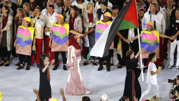 Palestine's Mayada Sayyad carries their country's flag as they lead teammates into the stadium during the opening ceremony of the Rio 2016 Olympic Games at the Maracana stadium in Rio de Janeiro on August 5, 2016.
Thomas COEX / AFP