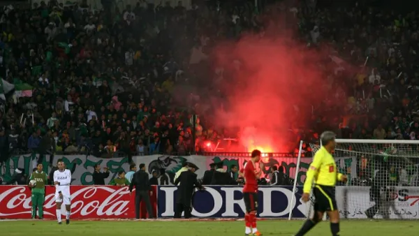 Egyptian fans of Al-Masry light flares during a football match against Al-Ahly in Port Said on February 1, 2012. At least 74 people were killed and hundreds injured when rival fans clashed after the football match, highlighting a security vacuum in post-revolution Egypt. AFP PHOTO/STR
STR / AFP