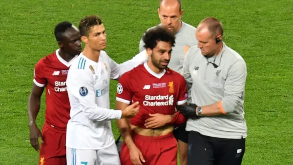 Liverpool's Egyptian forward Mohamed Salah (3rd R) is comforted by team members and Real Madrid's Portuguese forward Cristiano Ronaldo (2nd L) as he leaves the pitch after injury during the UEFA Champions League final football match between Liverpool and Real Madrid at the Olympic Stadium in Kiev, Ukraine on May 26, 2018.
Sergei SUPINSKY / AFP