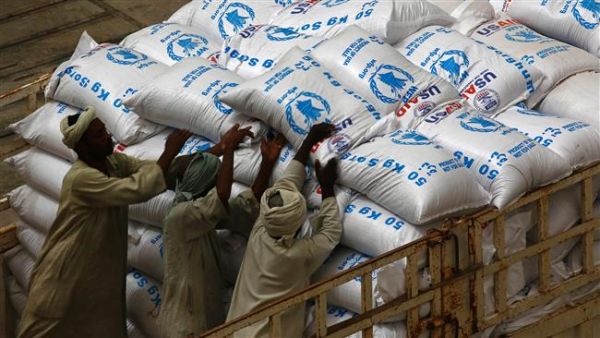 Sudanese workers offload US aid destined for South Sudan from the World Food Programme . (AFP/ File Photo)
