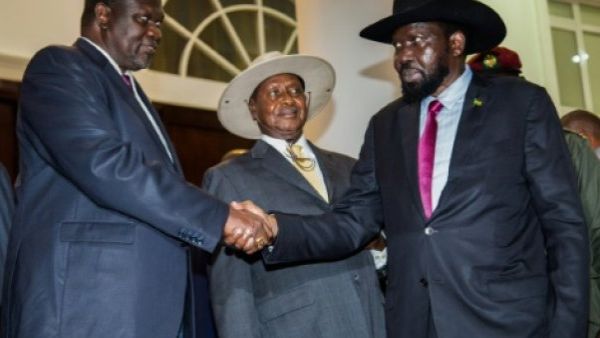 South Sudan's President Salva Kiir, right, shakes the hand of rebel leader Riek Machar in July. (AFP/File)