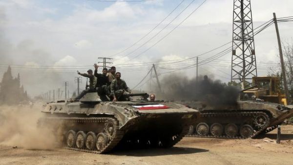 Syrian troops celebrate as they take control of the village of Western Dumayna, some seven kilometers north of the rebel-held city of Qusayr, on May 13 (Joseph Eid/ AFP)