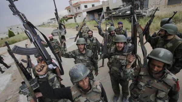 Syrian troops celebrate as they take control of the village of Haydariyah, some seven kilometers outside the rebel-held city of Qusayr (AFP/ Joseph Eid)