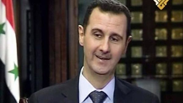 An image grab taken on May 30, 2013 from Lebanon's Shiite Muslim party Hezbollah's al-Manar TV shows Syrian President Bashar al-Assad smiles as she speaks during an interview with al-Manar in Damascus (al-Manar/ AFP)