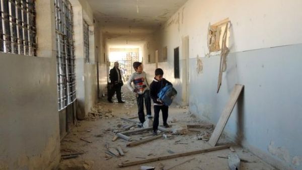 Syrian children search for their belongings at a school following airstrikes by Syrian government forces on December 22, 2013 in the northern Syrian city of Marea on the outskirts of Aleppo. [AFP]