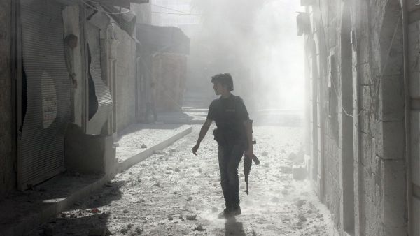 A soldier stands among debris inside Syria (AFP/FILE)