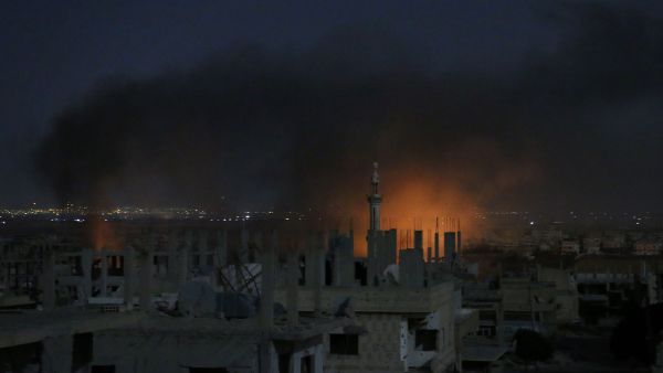 Smoke and flames rise from buildings following a reported government strike on a rebel-held area in Syria's southern city of Daraa late on July 3, 2017. (AFP)