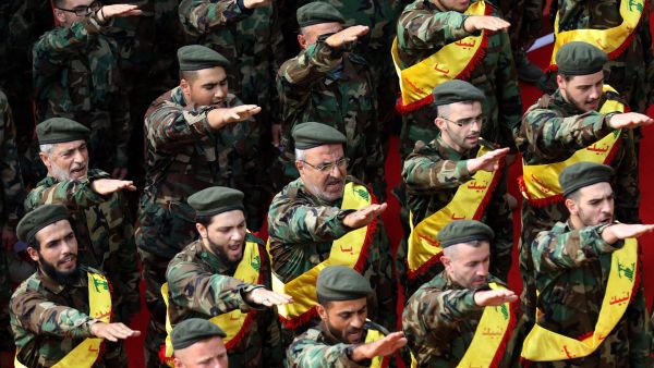 Hezbollah soldiers attend a funeral for a fallen fellow fighter in Syria (AFP/FILE)
