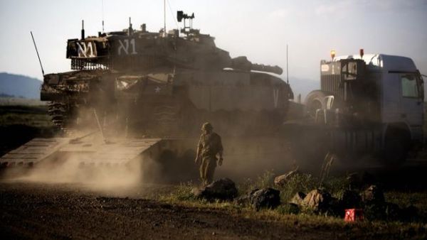 An Israeli Merkava tank is positioned for deployment during a drill in the Israeli annexed Golan Heights near the border with Syria on May 5, 2013. (Menahem Kahana/AFP)