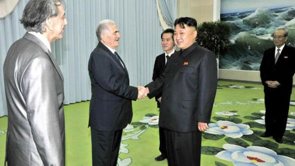 This picture, taken by North Korea's official Korean Central News Agency on July 24, 2013 shows North Korean leader Kim Jong-Un shaking hands with Abdullah al-Ahmar, deputy general secretary of the Syria's Baath Arab Socialist Party in Pyongyang.  "AFP PHOTO / KCNA VIA KNS" 