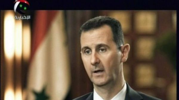 Syrian President Bashar al-Assad gives an interview to a Syrian state news channel (AFP)