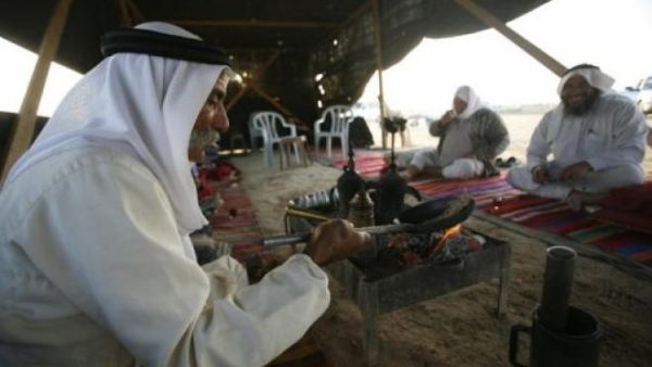 Bedouin men enjoy one another's company over traditional Arabic coffee in their tent in Israel's Negev desert. (AFP/File)