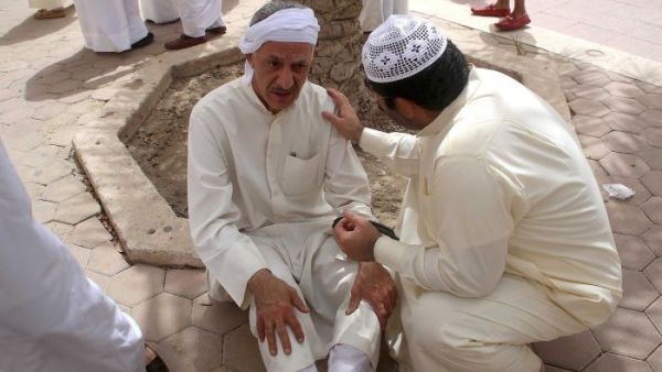 A Kuwaiti man is consoled at the site of Friday's Daesh-perpetrated bombing on a Shiite mosque in Kuwait City.  (AFP/Yasser al-Zayyat)