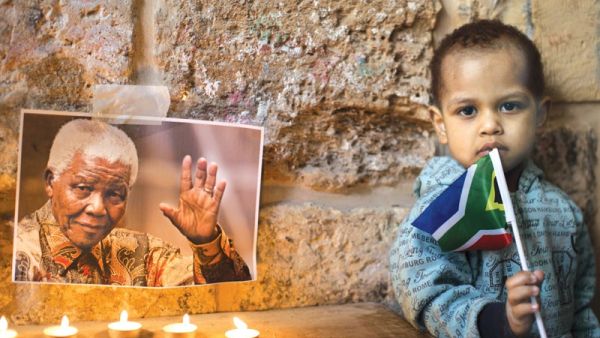Members of the African-Palestinian community in Jerusalem's Old City attend a ceremony commemorating South African leader Nelson Mandela.  Many have likened Mandela's fight against apartheid to Palestinians' struggle against Israeli occupation.  (AFP/File)