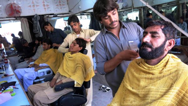 Men get their beards trimmed at a barber shop in Pakistan, July 2014.  (AFP/File)