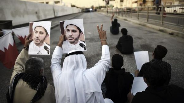 Bahraini demonstrators hold up photos of detained Shiite cleric and opposition leader Sheikh Ali Salman in a suburb of the capital Manama.  (AFP/Mohammed al-Shaikh)