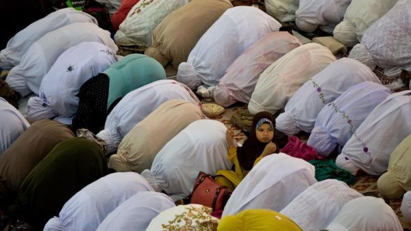 Women perform prayers at a mosque in Kuala Lumpur, Malaysia. (AFP/Manan Vatsyayana)