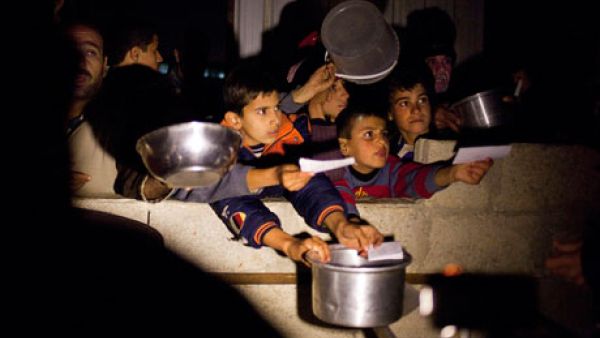 Syrian children beg for food at border crossing area in Syria. [guardian]