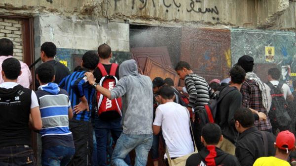 Egyptian students of al-Azhar University block the access to an administration building during an anti-army protest on October 30, 2013 at the university in Cairo. [KHALED KAMEL/AFP/Getty Images]