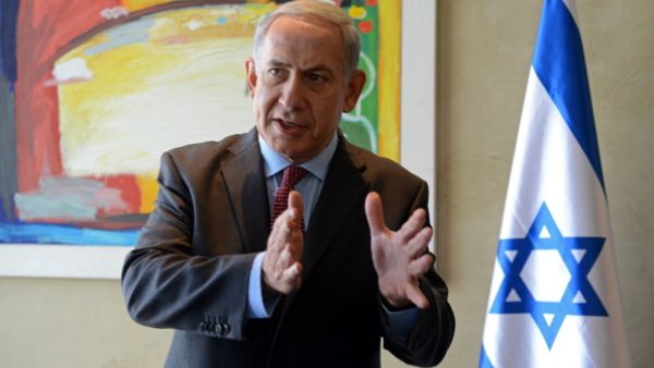 Israeli Prime Minister Benjamin Netanyahu speaks to the press following his meeting with US Secretary of State at Ben Gurion airport near Tel Aviv on November 8, 2013. [Getty Images]