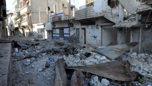 A picture taken on November 13, 2013, shows debris and damaged buildings in the town of Hujeira south of the Syrian capital Damascus. [AFP]