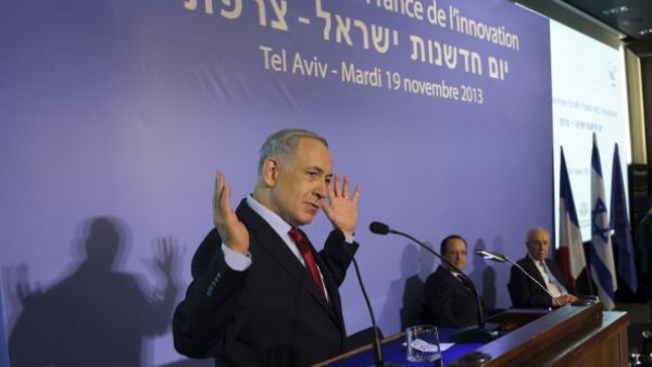 Israeli Prime Minister Benjamin Netanyahu delivers a speech attended by French President Francois Hollande and Israel's President Shimon Peres in Tel Aviv on November 19, 2013. [Getty Images]