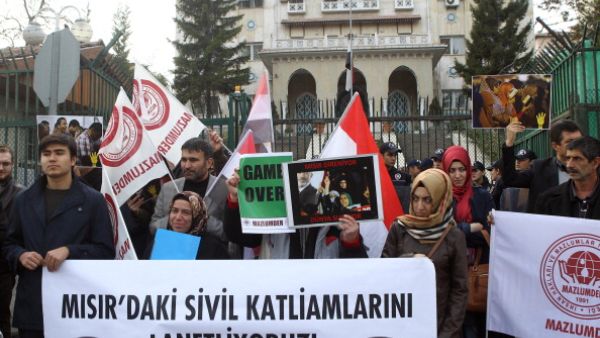 Ousted Egyptian President Morsi's supporters demonstrate against the current Egyptian government in front of the Egyptian embassy in Ankara on November 22, 2013. 