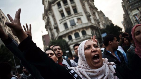 Egyptian Activists and members of the 6th of April movement shout slogans against the Egyptian Military on November 27, 2013, in Cairo. [Gianluigi Guercia/AFP]