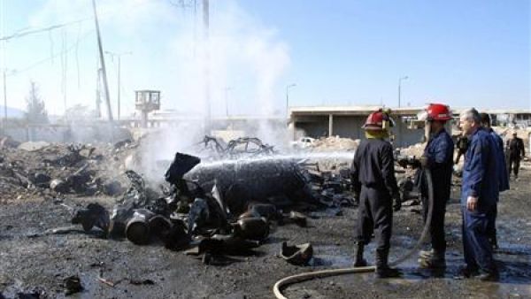 Fire-fighters extinguish a vehicle on fire after a suicide bomber in a truck carried out an attack at the eastern entrance of Hama city ,October 20, 2013. [Reuters/SANA/Handout]
