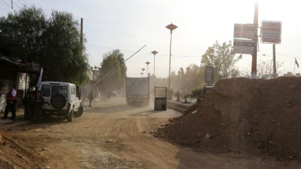 Aid convoys prepare to enter Moadimayet al-Sham, a rebel-held town near the Syrian capital Damascus, on February 17, 2016, during an operation to deliver aid to thousands of besieged Syrians.  (AFP/Louai Besharra)