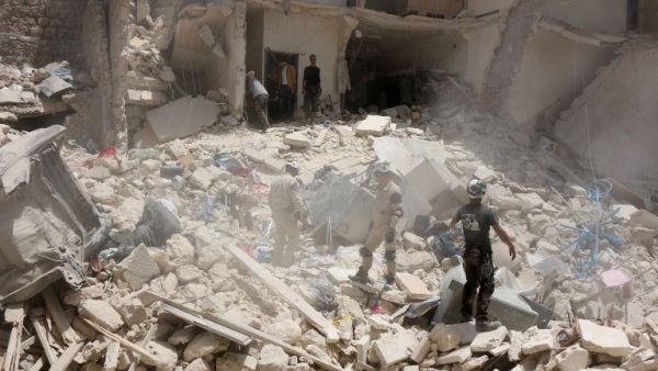 Syrian rescuers search the rubble of a destroyed building following a reported Syrian government forces attack at the Tariq al-Bab neighborhood in the rebel-held area of Aleppo on June 20, 2016. (AFP/Thaer Mohammed)