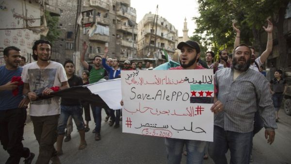 Syrians shout slogans during an anti-regime protest in the rebel-held Bustan al-Qasr district in eastern Aleppo on May 5, 2016. (AFP/Karam al-Masri) Syrians shout slogans during an anti-regime protest in the rebel-held Bustan al-Qasr district in eastern Aleppo on May 5, 2016. (AFP/Karam al-Masri)