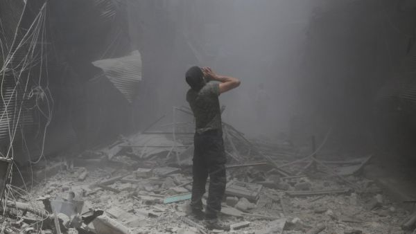 A Syrian man reacts following a reported air strike by Syrian government forces in the rebel-held neighborhood of Bustan al-Qasr on June 5, 2016. (AFP/Baraa al-Halabi)