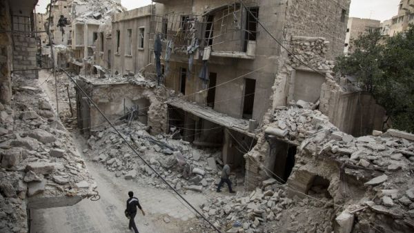 A Syrian man walks past destroyed buildings on May 2, 2016, in Aleppo's Bab al-Hadid neighbourhood which was targeted recently by regime air strikes. (AFP/Karam al-Masri)