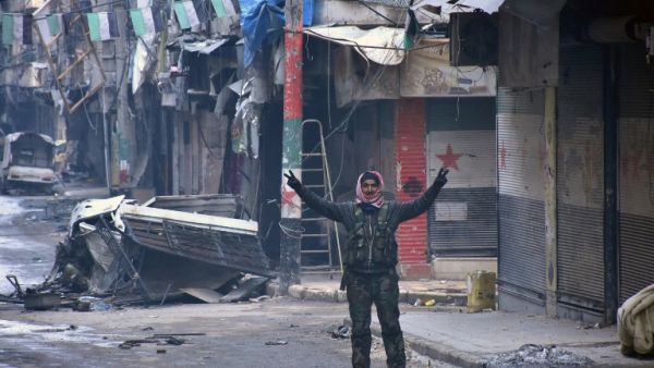 A Syrian man gestures in the former rebel-held Salaheddin district in the northern Syrian city of Aleppo on December 23, 2016 after Syrian government forces retook control of the whole embattled city. (AFP/George Ourfalian)