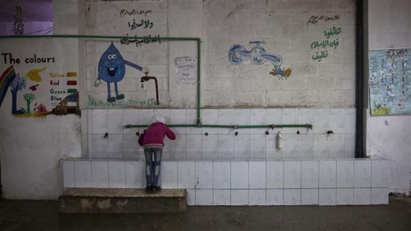 A Syrian girl drinks water at a school near Damascus on October 19, 2016. (AFP/File)