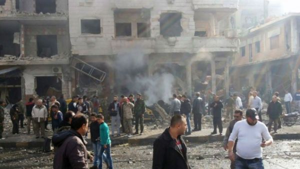 In this photo released by the Syrian official news agency SANA, residents gather at the scene where two blasts exploded in the pro-government neighborhood of Zahraa, in Homs province, Syria, Sunday, Feb. 21, 2016. (AFP/File)