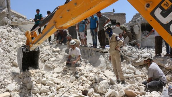 Syrian civil defense workers look for survivors under the rubble of a collapsed building following reported air strikes on July 17, 2016 in the rebel-controlled neighborhood of Karm Homad in the northern city of Aleppo. (AFP/Thaer Mohammed) Syrian civil defense workers look for survivors under the rubble of a collapsed building following reported air strikes on July 17, 2016 in the rebel-controlled neighborhood of Karm Homad in the northern city of Aleppo. (AFP/Thaer Mohammed)