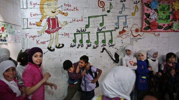 Syrian children play in one of the underground rooms of the Al-Hayat school in Damascus' north eastern rebel-held al-Qaboun surburb, which is under a truce with the regime, on October 19, 2016. (AFP/Sameer al-Doumy)